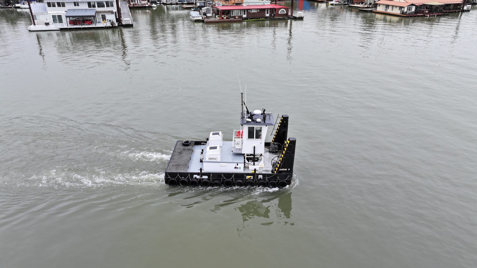 AARON P. tug underway with houseboats in background