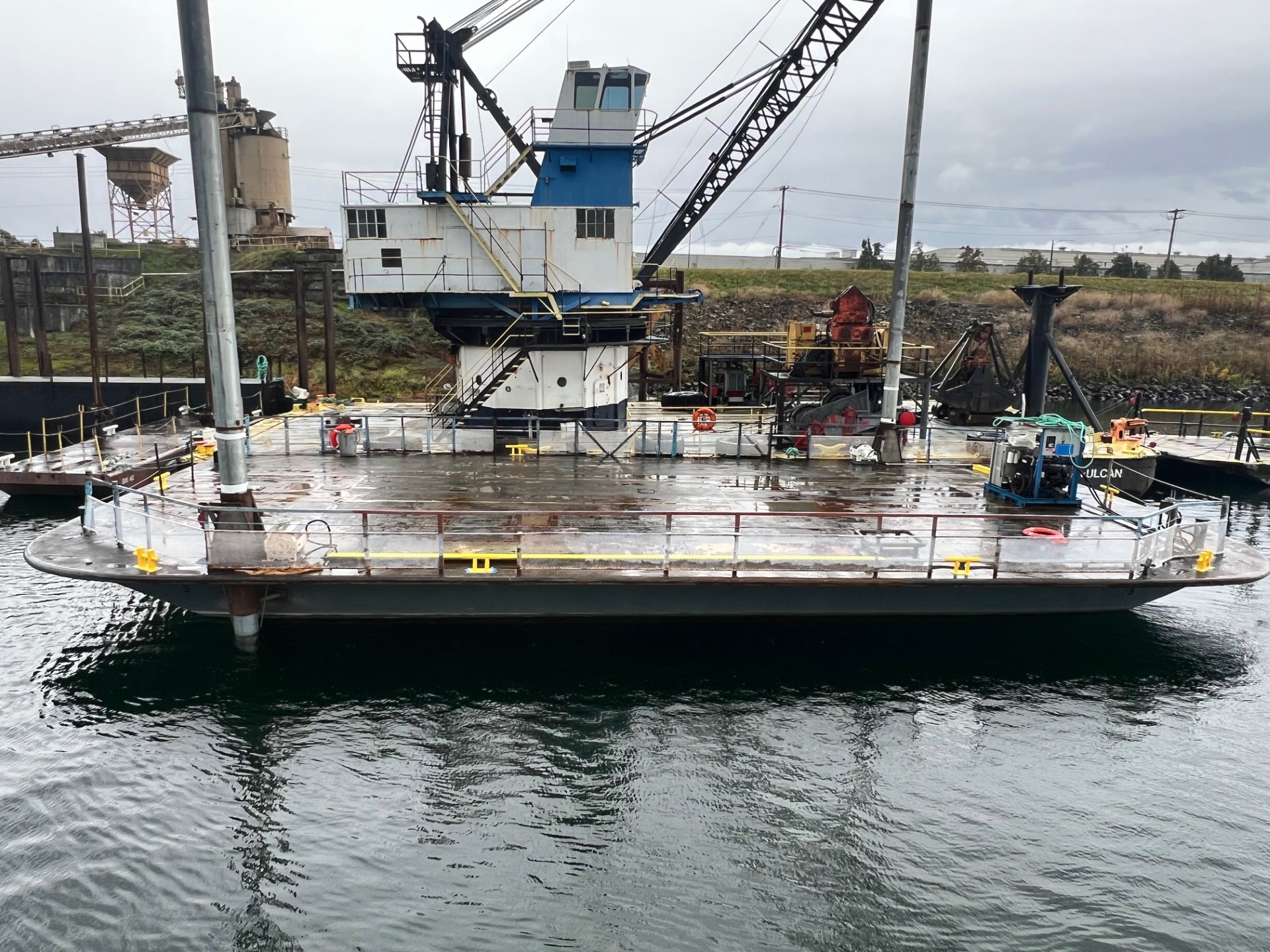 AX75 spud barge at the yard with crane onboard