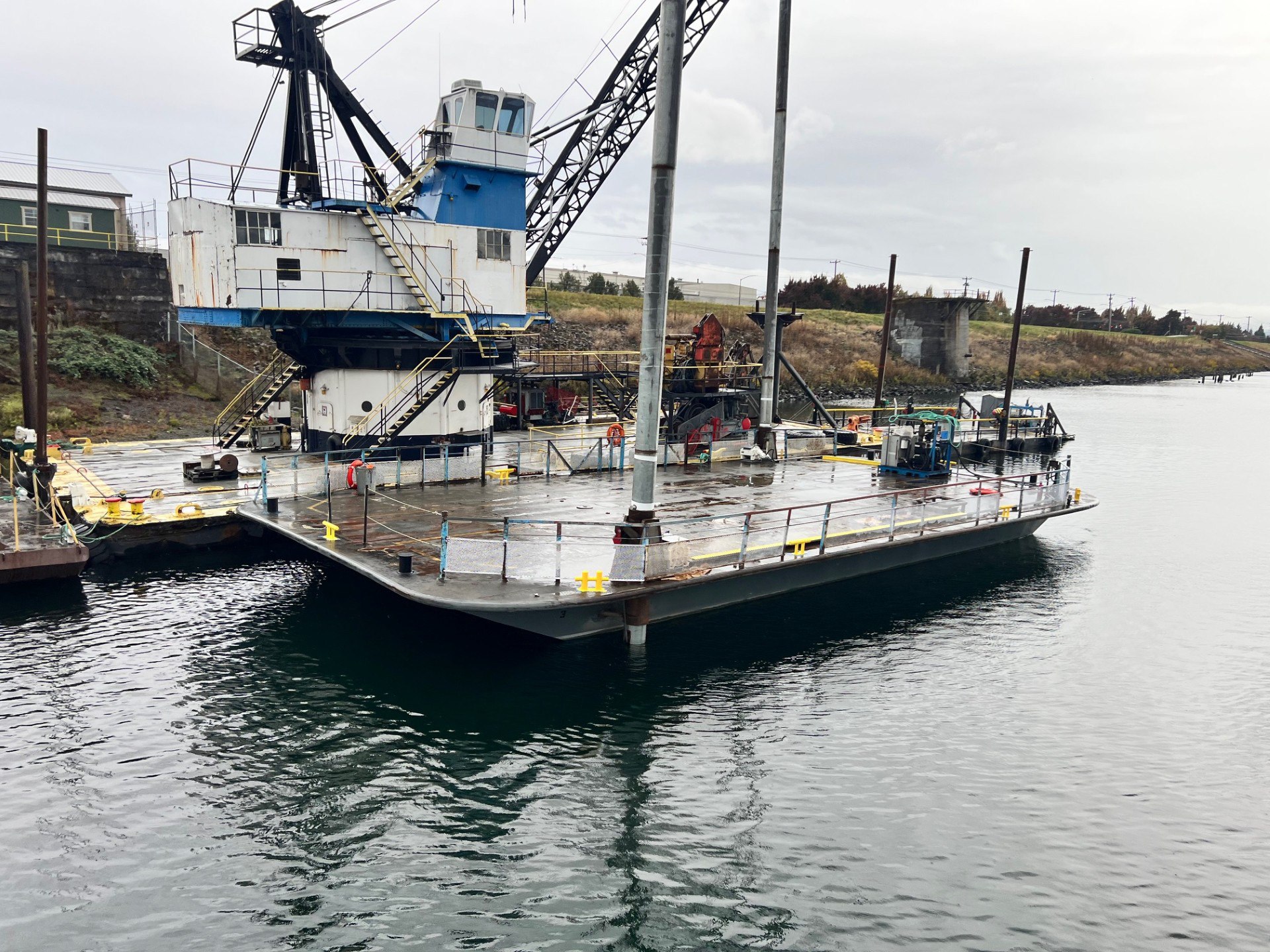 AX75 spud barge moored alongside