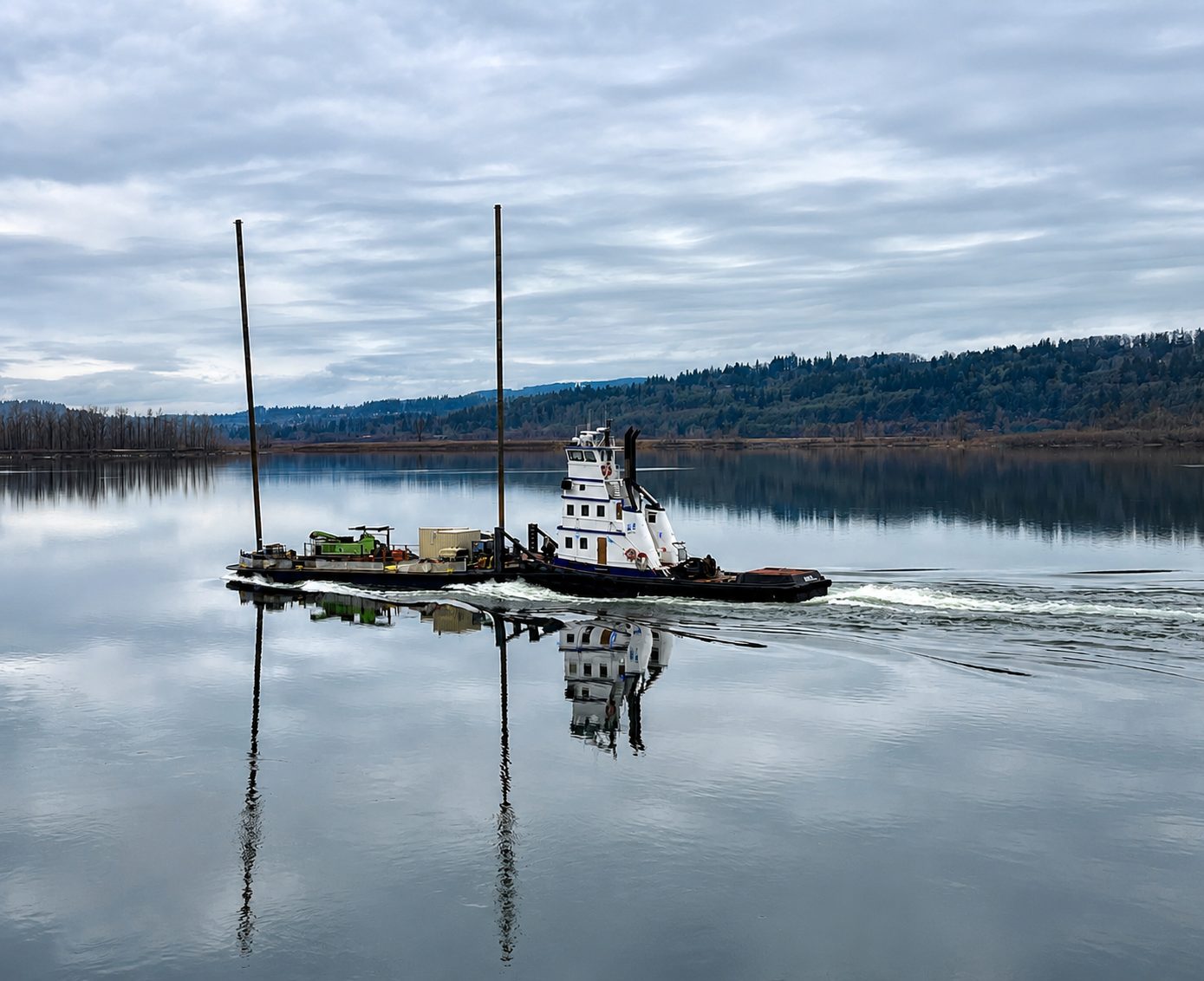 AX75 spud barge being pushed by MARINER with mirror reflection on the Columbia