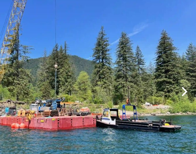THE GENERAL working alongside a crane barge at a remote reservoir