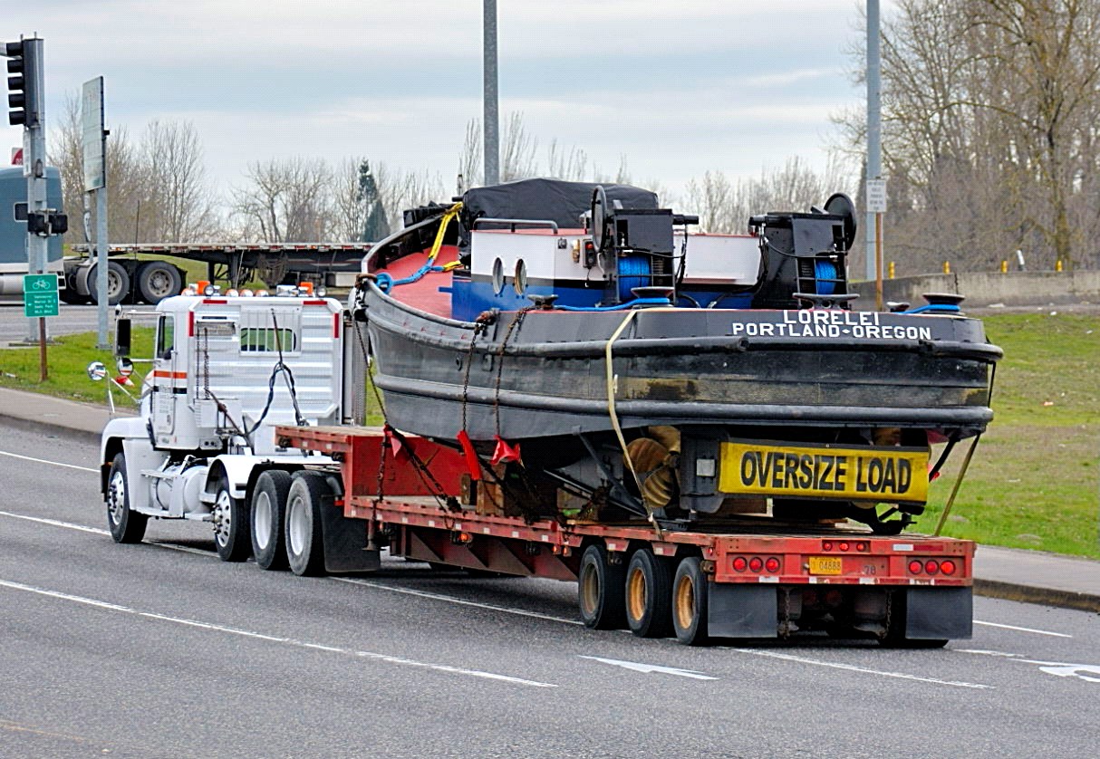 LORELEI on a lowboy trailer being transported by road
