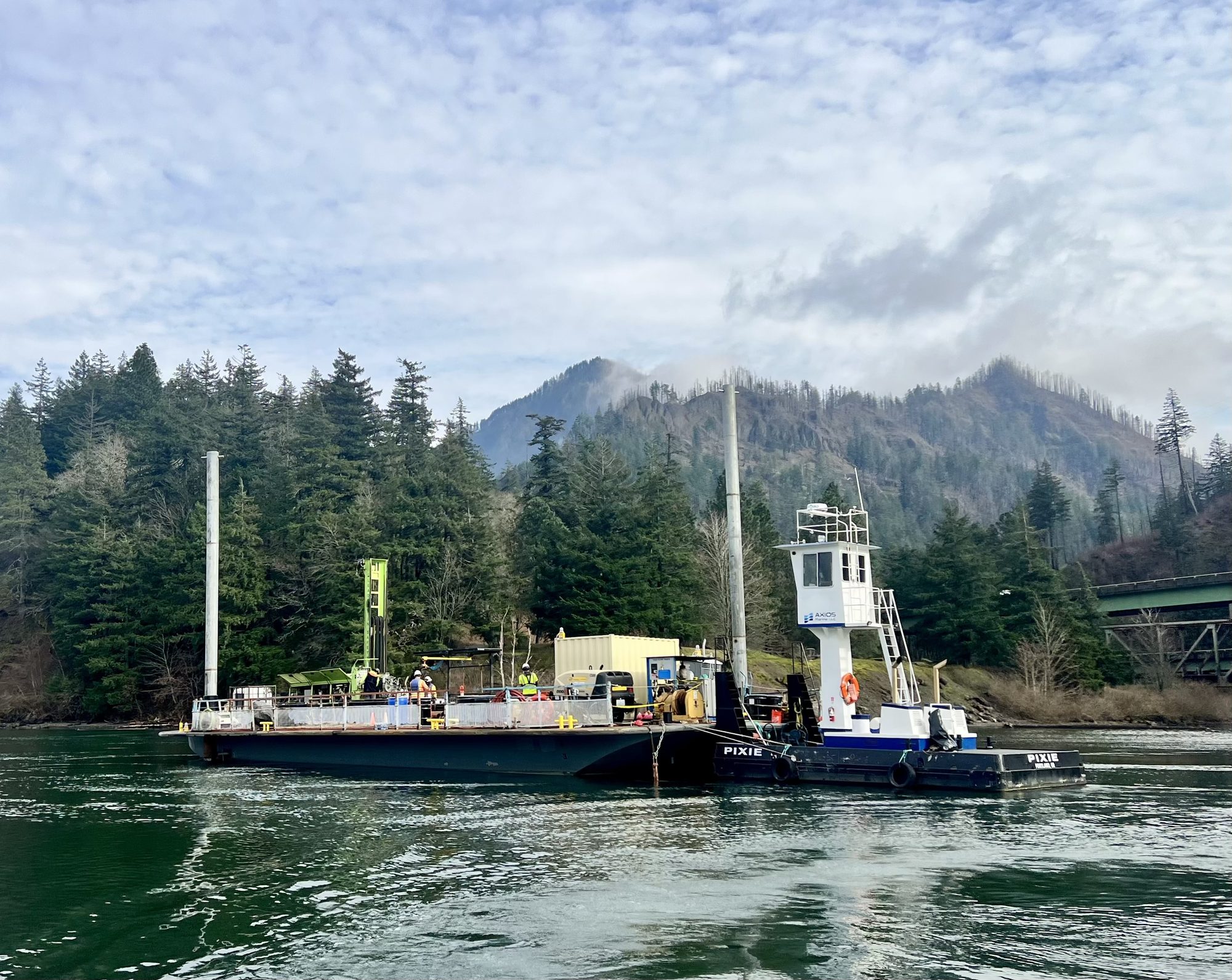 PIXIE pushing the AX75 spud barge with drill rig in the Cascades
